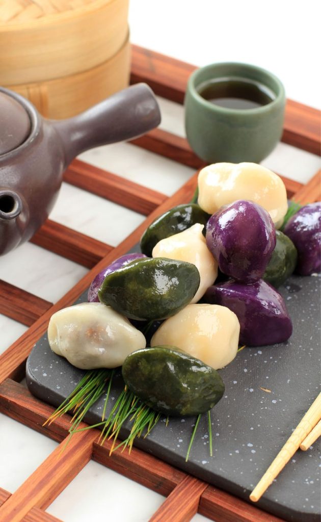 Plain, mugwort, and purple sweet potato songpyeong on a plate during a Korean tea session.
