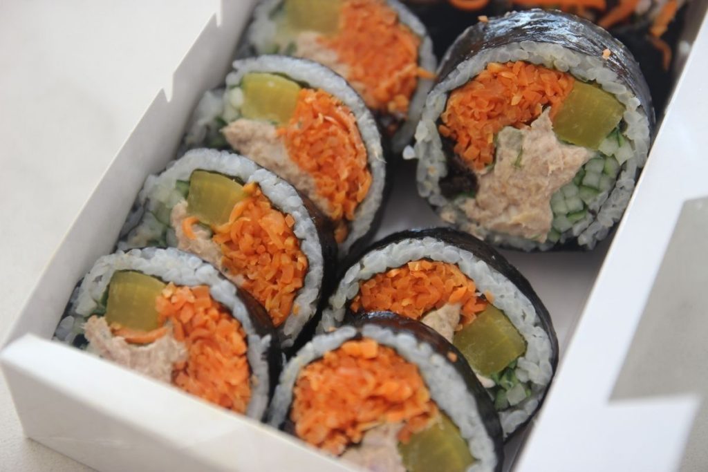 Tuna gimbap sliced up in a takeaway box